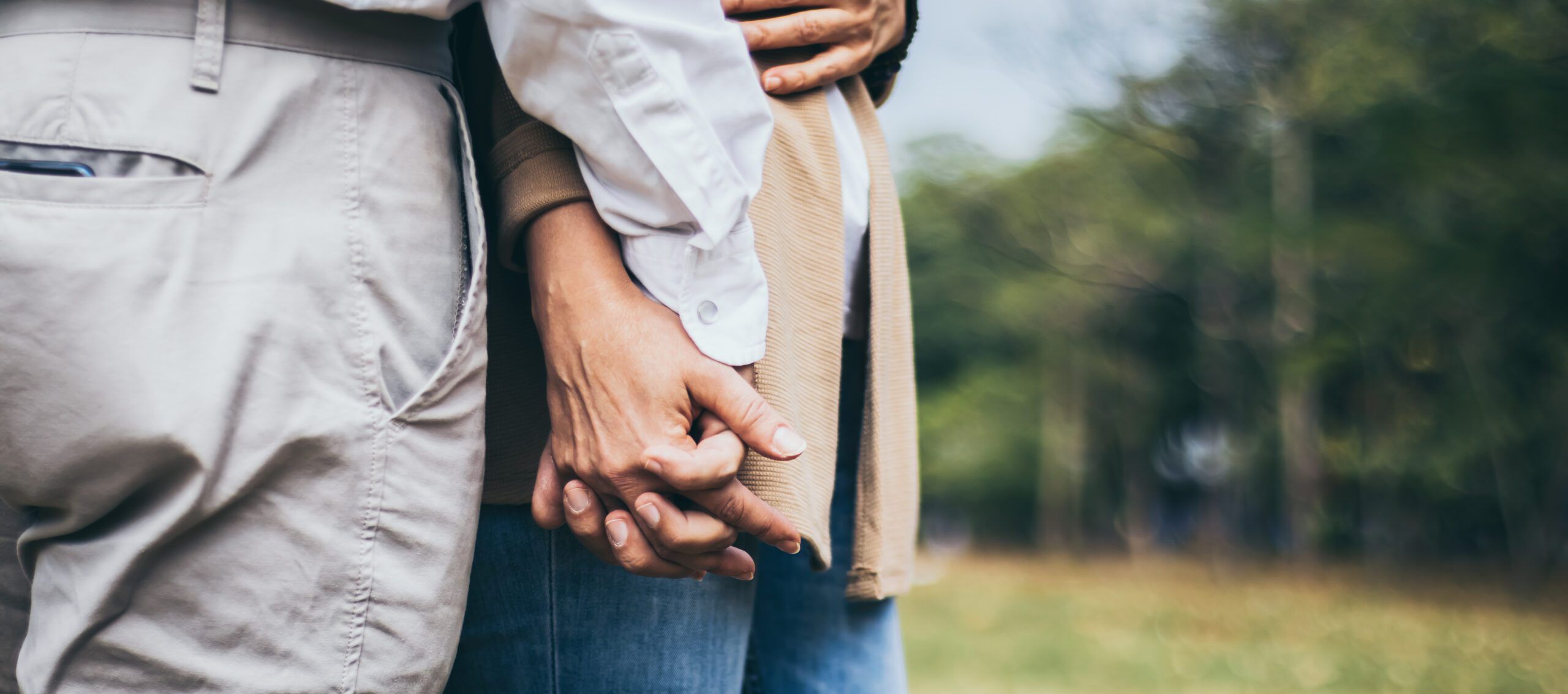 Lovely senior elderly smiling couple man and woman holding hand as promising of forever love or take care in romantic moment. Warm heart marriage and lover bonding and relationship. Love photo concept