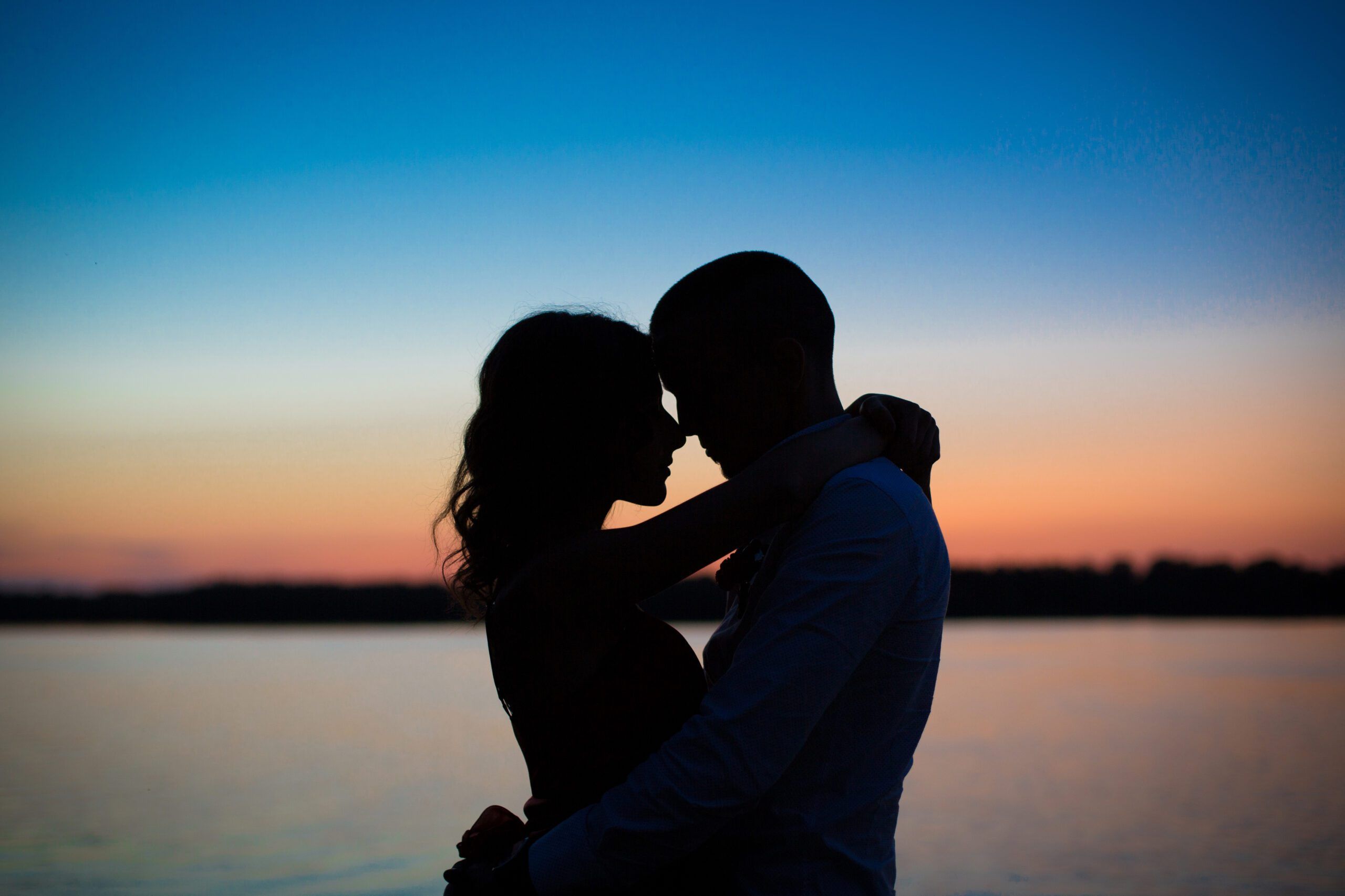 Silhouettes of a couple in love romance at sunset.